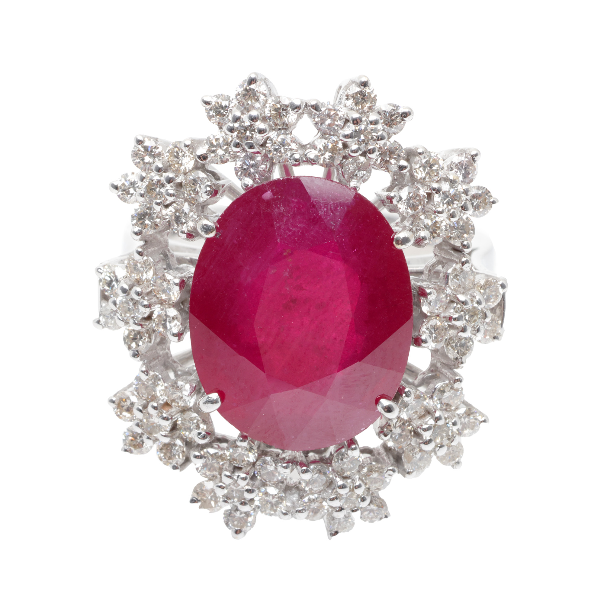 White gold ring, decorated with central ruby, surrounded by diamond pave flowers