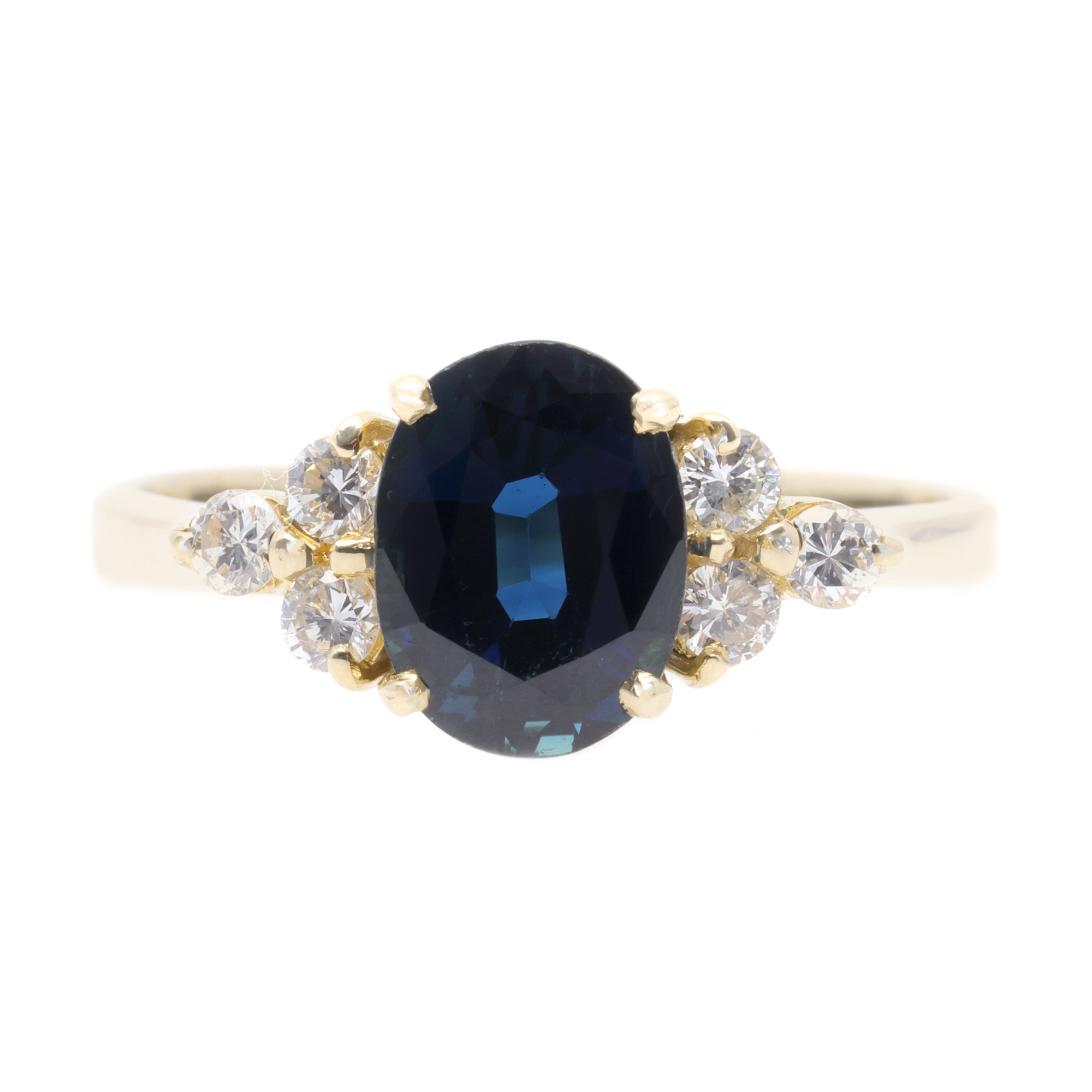 Gold ring, decorated with six diamonds and a central sapphire