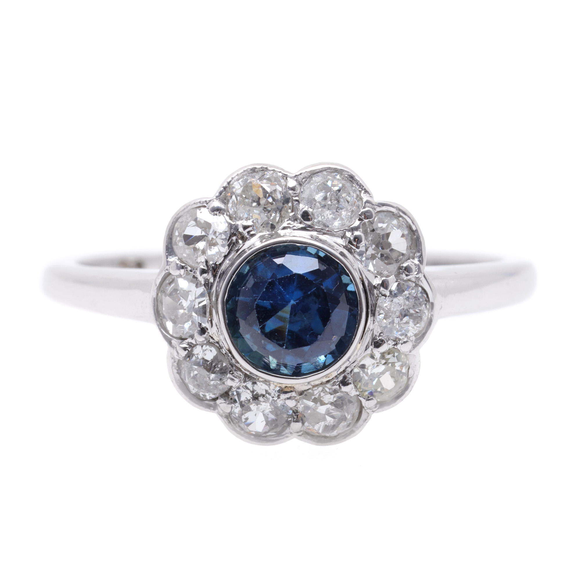 White gold ring, decorated with a central sapphire, surrounded by diamonds
