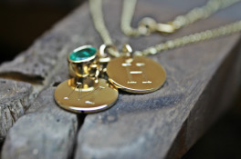 9K GOLD DISC PENDANTS WITH A 1.19CT OVAL EMERALD