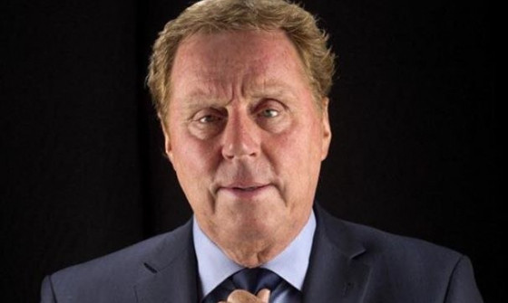 Harry Redknapp adjusts his tie looking into the camera