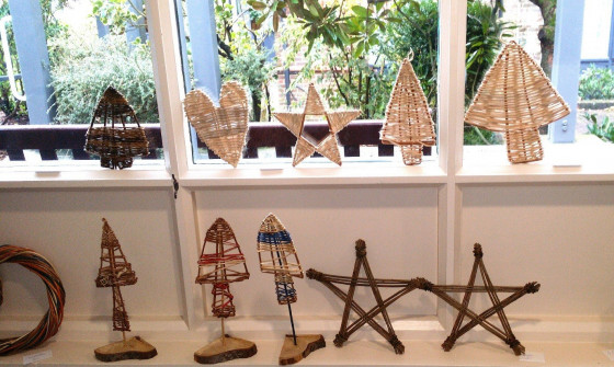 Willow Christmas craft pieces sit on a windowsill. The pieces include willow trees, hearts and stars.