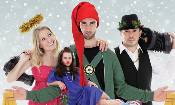 A close up shot of four cast members. They are all wearing outrageous costumes
