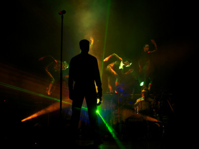 A Gary Numan tribute faces away from the camera under green lighting