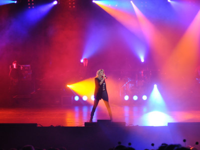 A Kim Wilde tribute stands on stage singing out to an audience