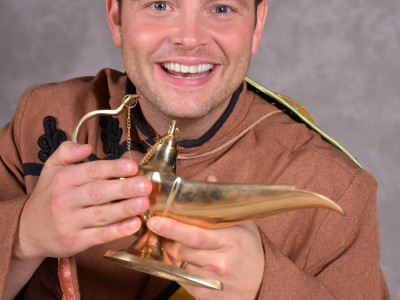 Mark Rhodes rubs a lamp dressed as Aladdin