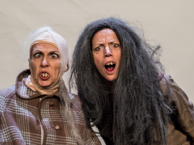 Two characters with false teeth look in shock at the camera