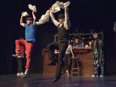 Two performers dance in unison
