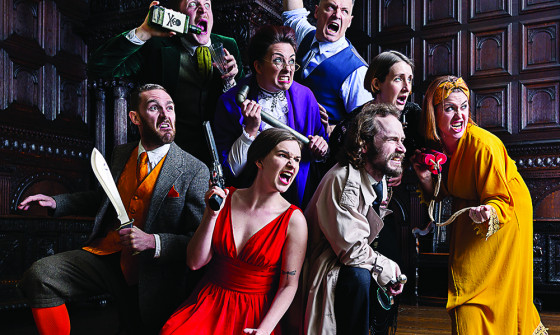The cast of Murder, She Didn't Write: The Improvised Murder Mystery stand in a group aggressively holding murder weapons