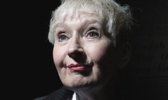 Sue Pollard looks beyond the camera, smiling.