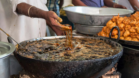Superhands! Meet the man who dips his BARE HANDS into BOILING OIL to fry fish