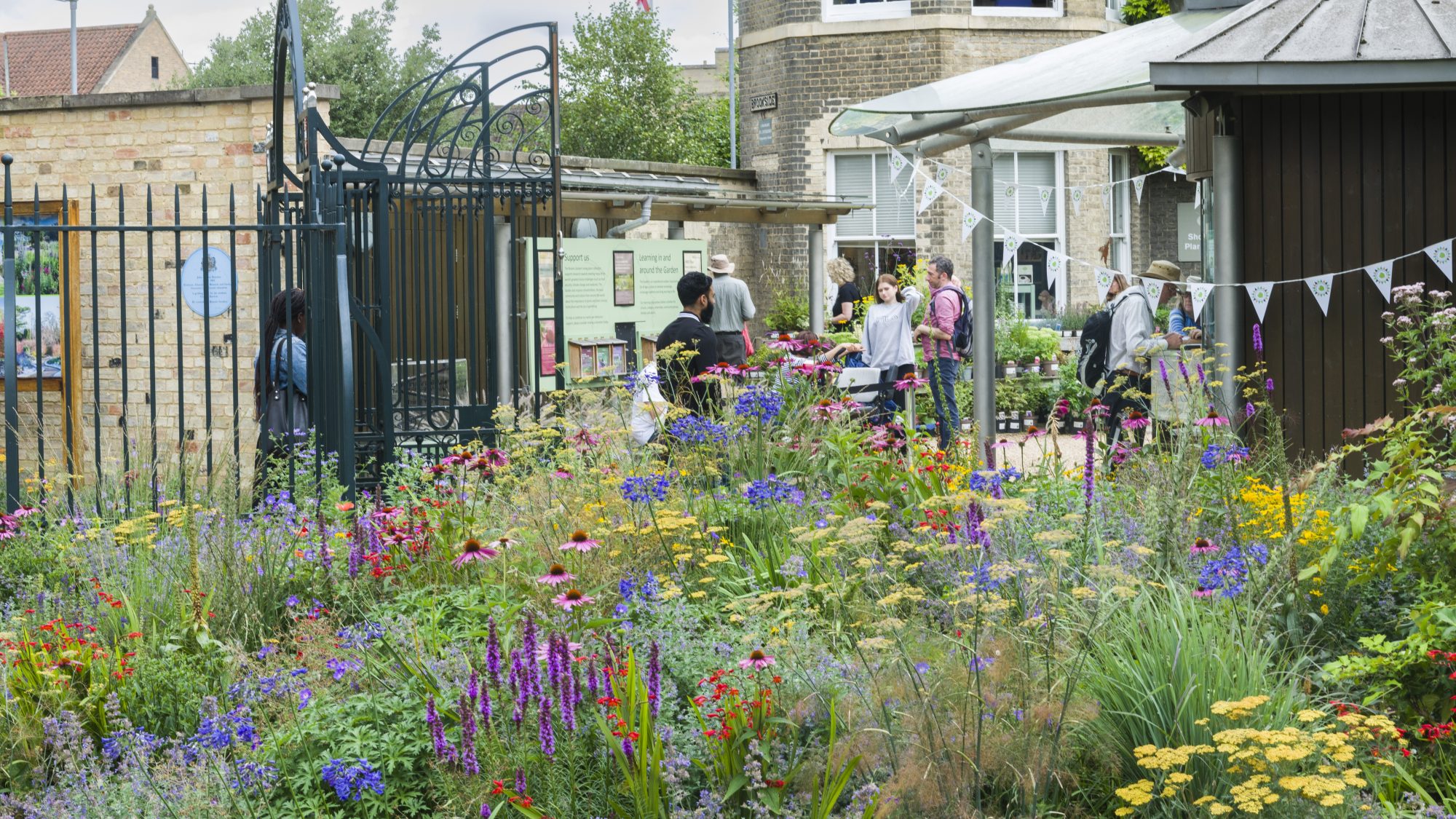 Two visitors arriving at the entrance gates and Ticket Office