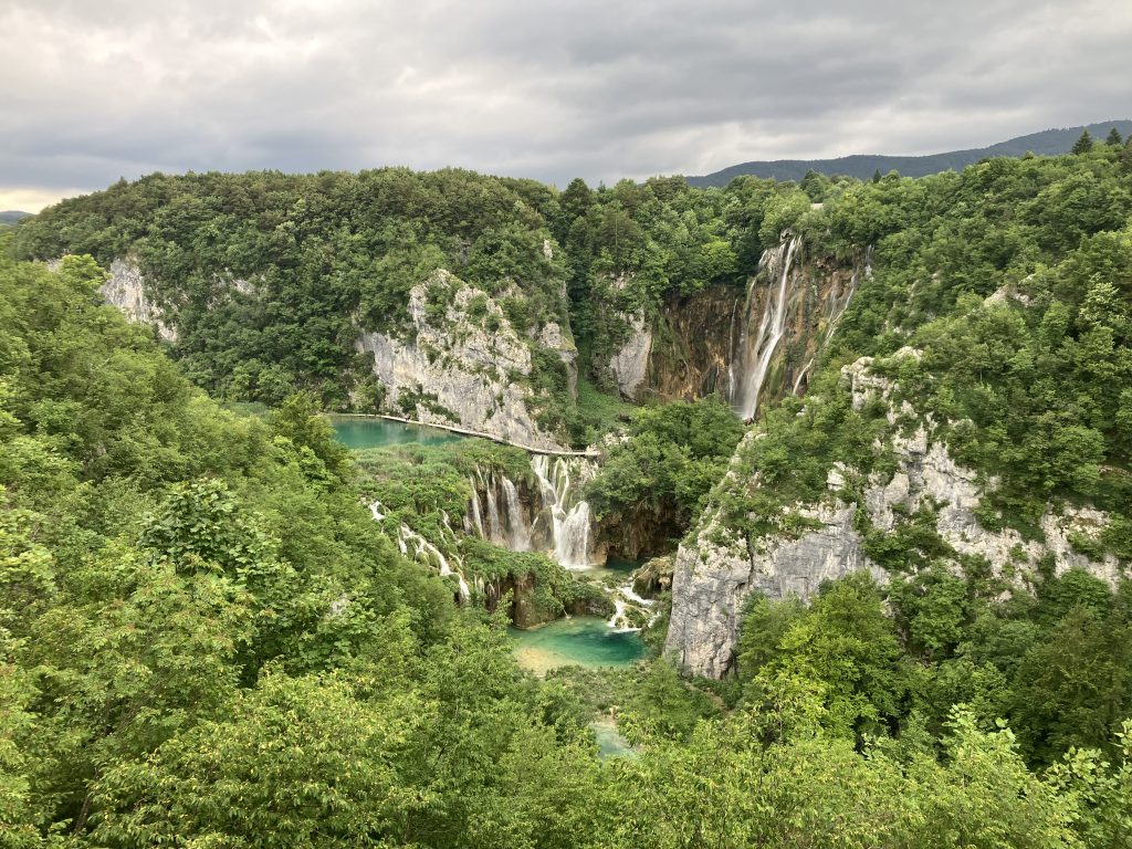 Plitvice Lakes National Park in Croatia, showcasing stunning turquoise lakes and cascading waterfalls surrounded by lush greenery.