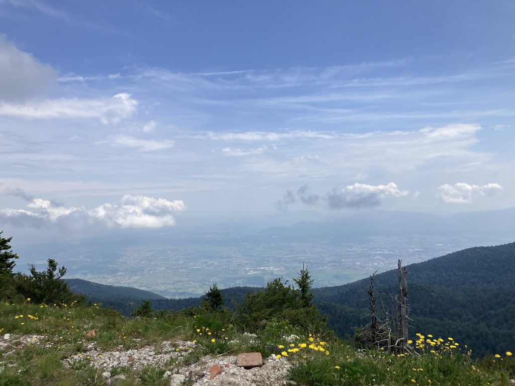 A view from the top of the mountain to the fields and clouds below.