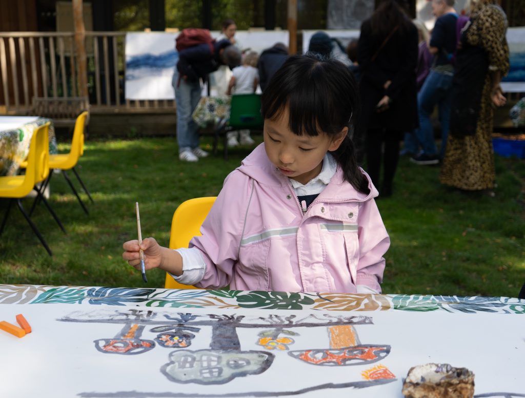 A child painting a picture of fungi
