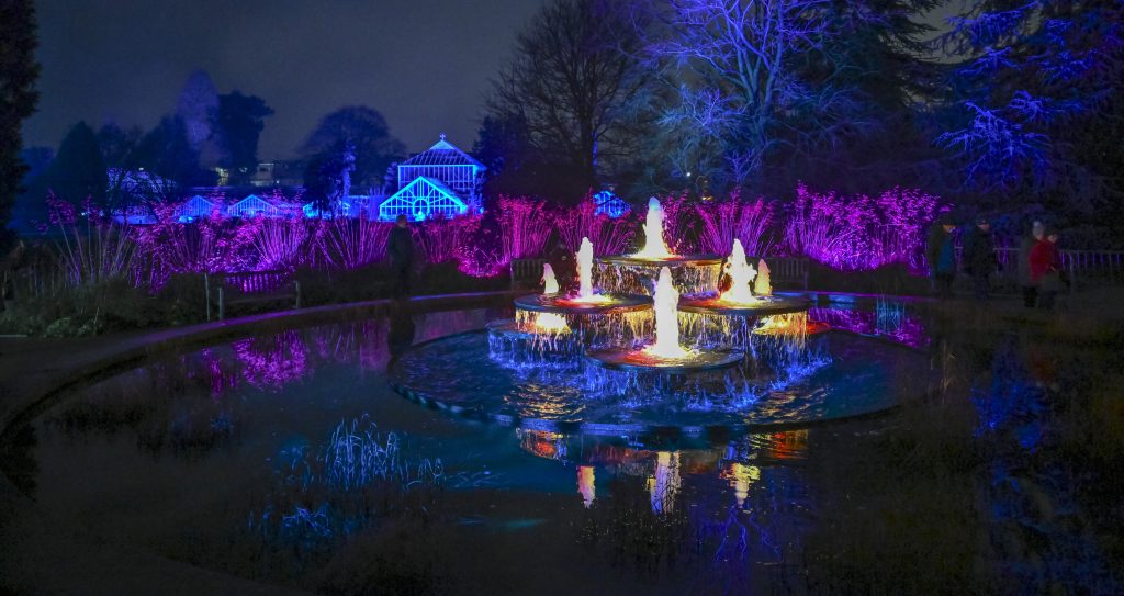 the fountain illuminated in the foreground, with the Glasshouse Range lit up in the backgrouond