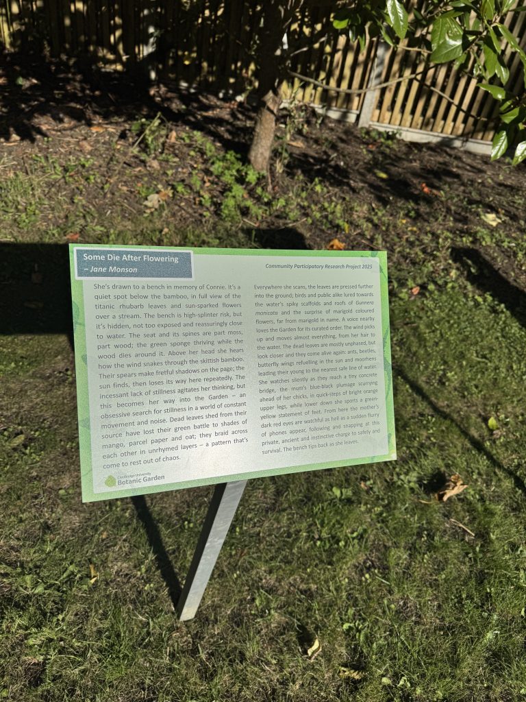 A raised sign showing a poem in Cambridge University Botanic Garden.