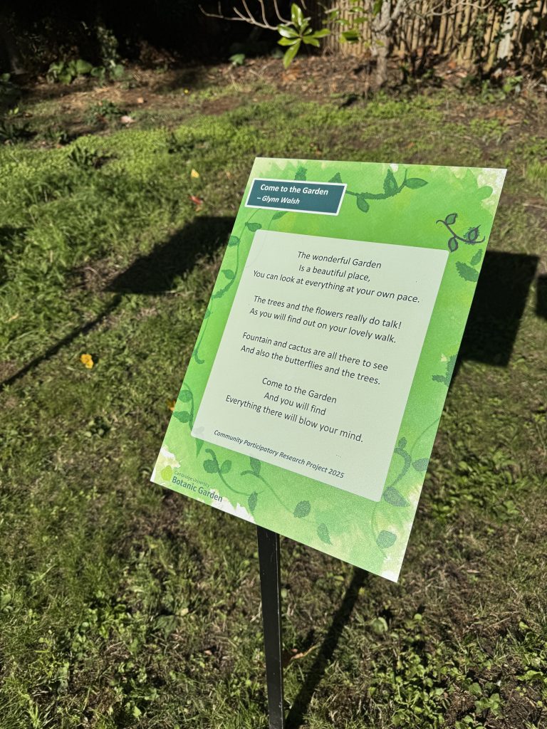 A raised sign showing a poem in Cambridge University Botanic Garden.