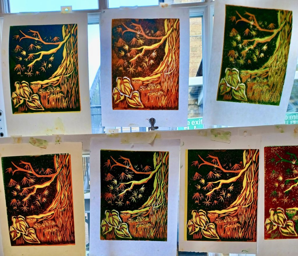 a linocut image of tree trunks