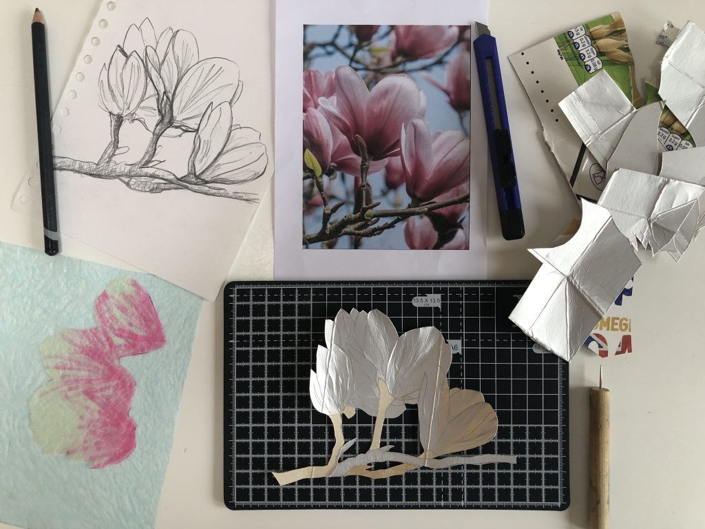 A plaster cast of stems and flowers in a tissue padded box
