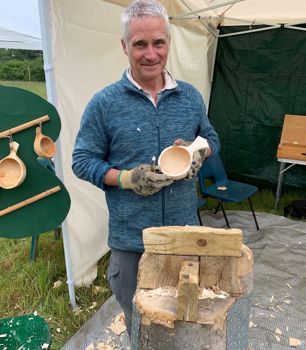 A man holding a hand carved wooden bowl
