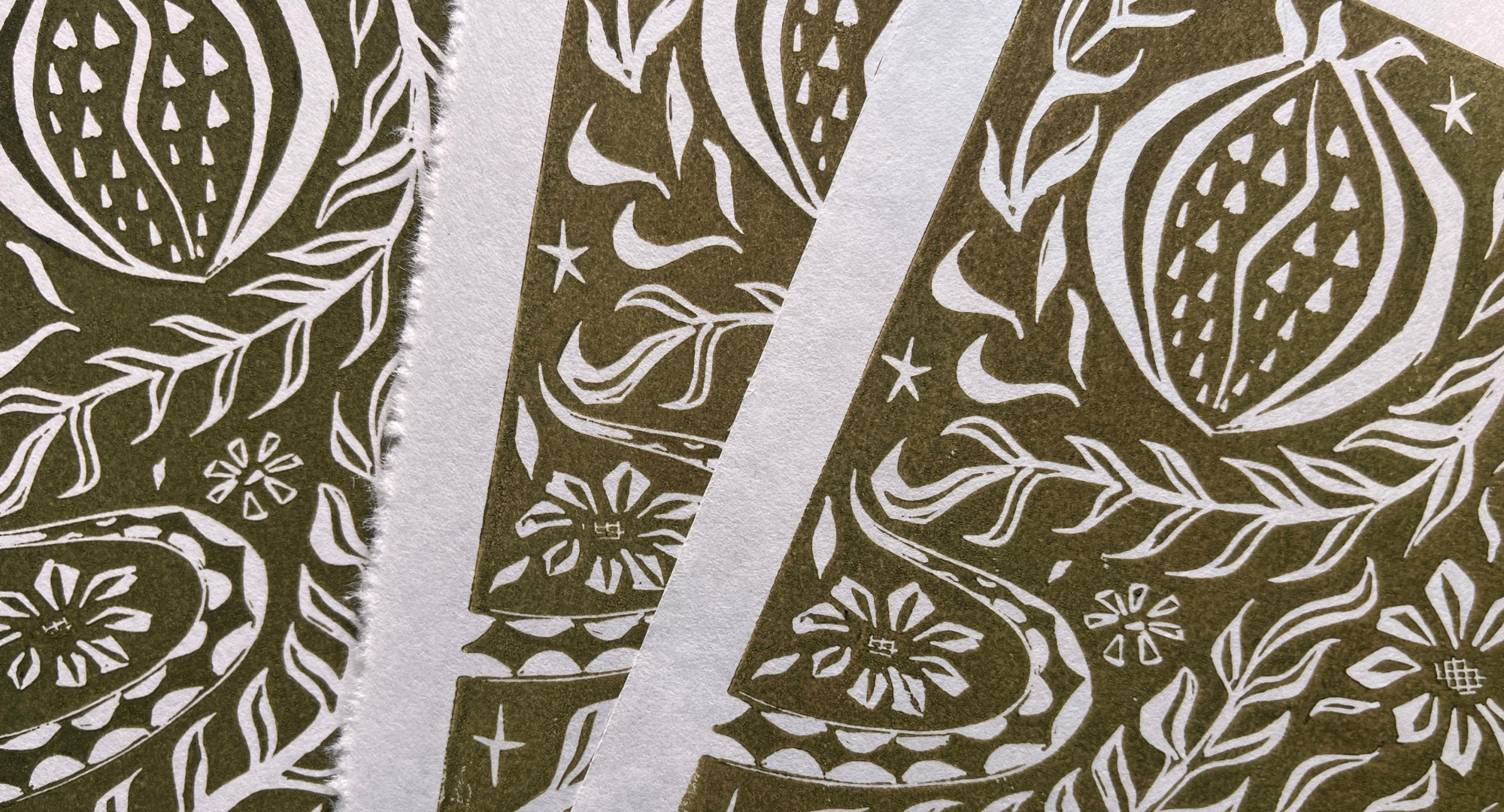 an abstract linocut image of flowers and fruits