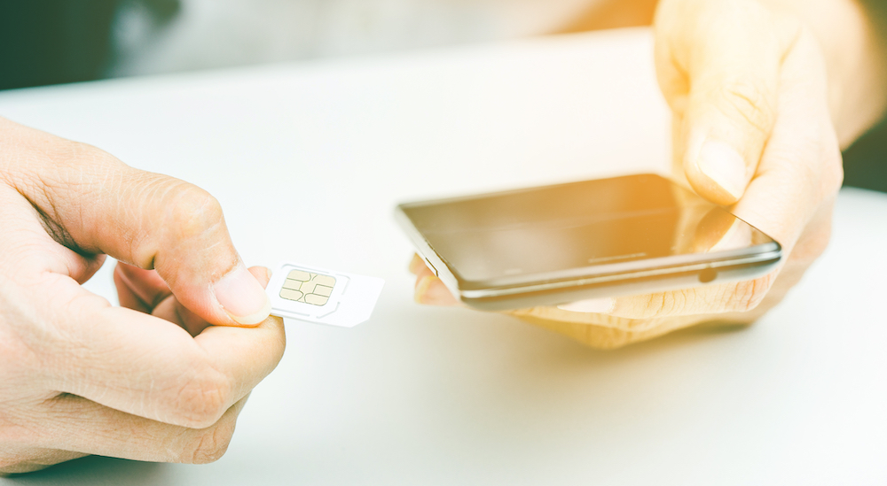 someone holding a mobile sim
