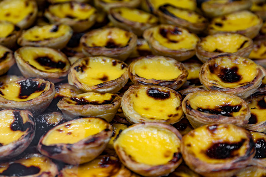 Portugese pastries, pasteis de nata in a bakery store.