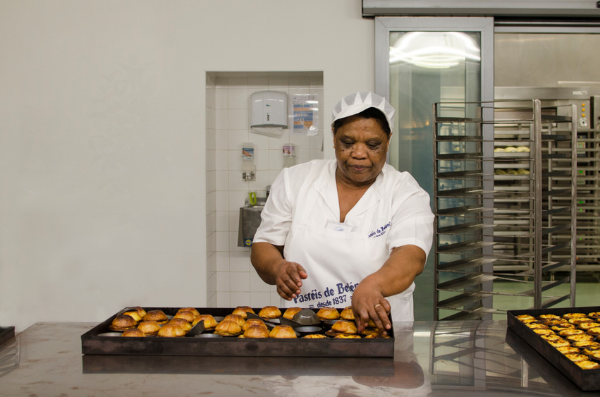 Lisbon, Portugal - January 26th, 2014: Woman making pasteis de nata in the Pasteis de Belem bakery in Lisbon, Portugal