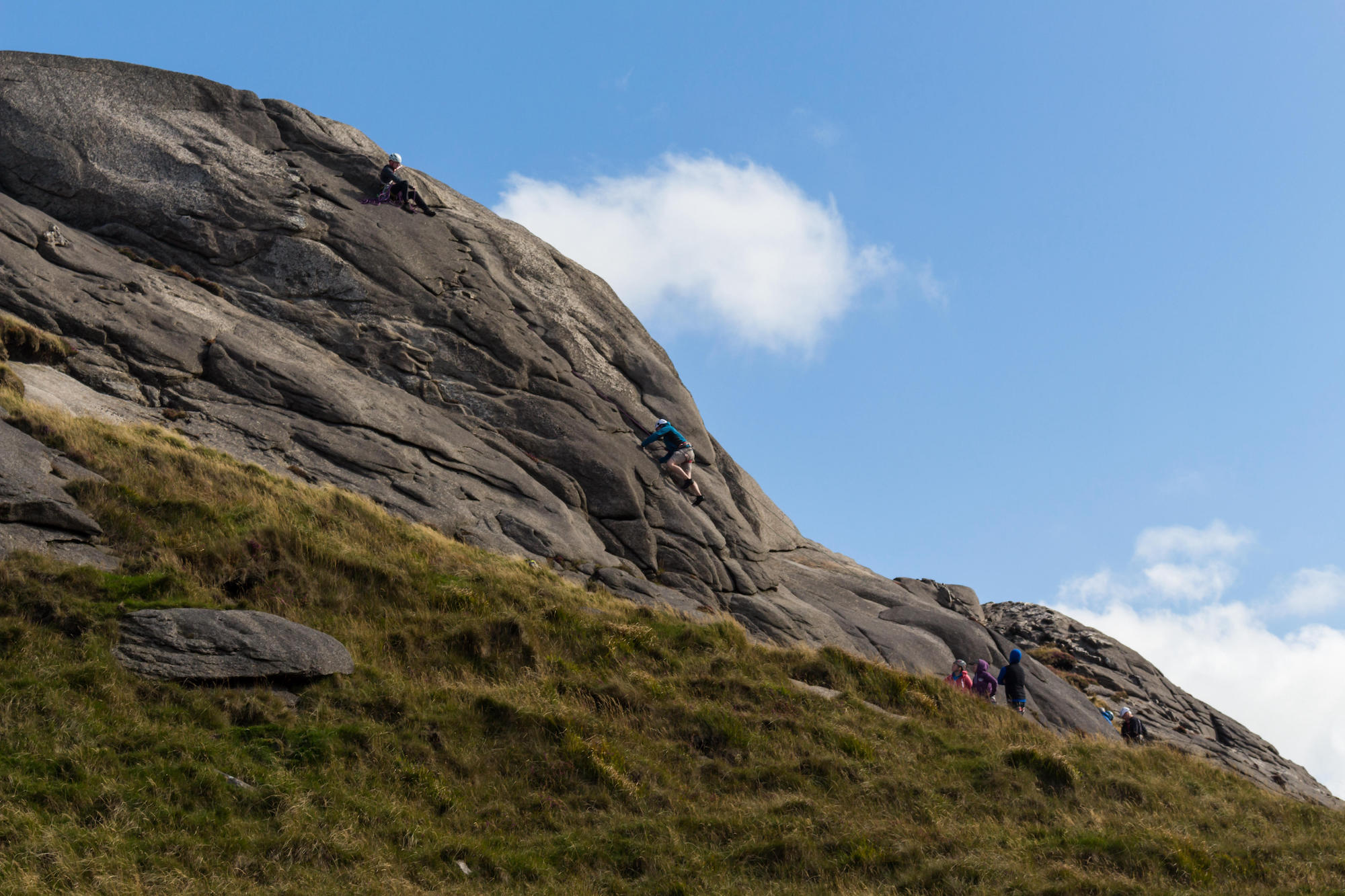 A learner climber being belayed from above on a crag on Hen Mountain, Mourne Mountains, N.Ireland. Nordirland To Dos