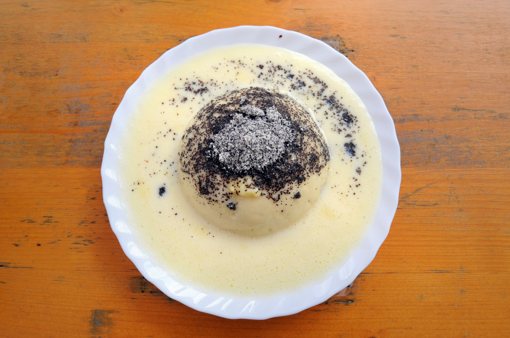 Germknoedel is typical Austrian food. its a fluffy yeast dough dumpling with a mix of poppy seeds and sugar, filled with jam and eaten with vanilla cream.