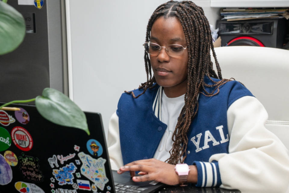 a woman looking at her laptop