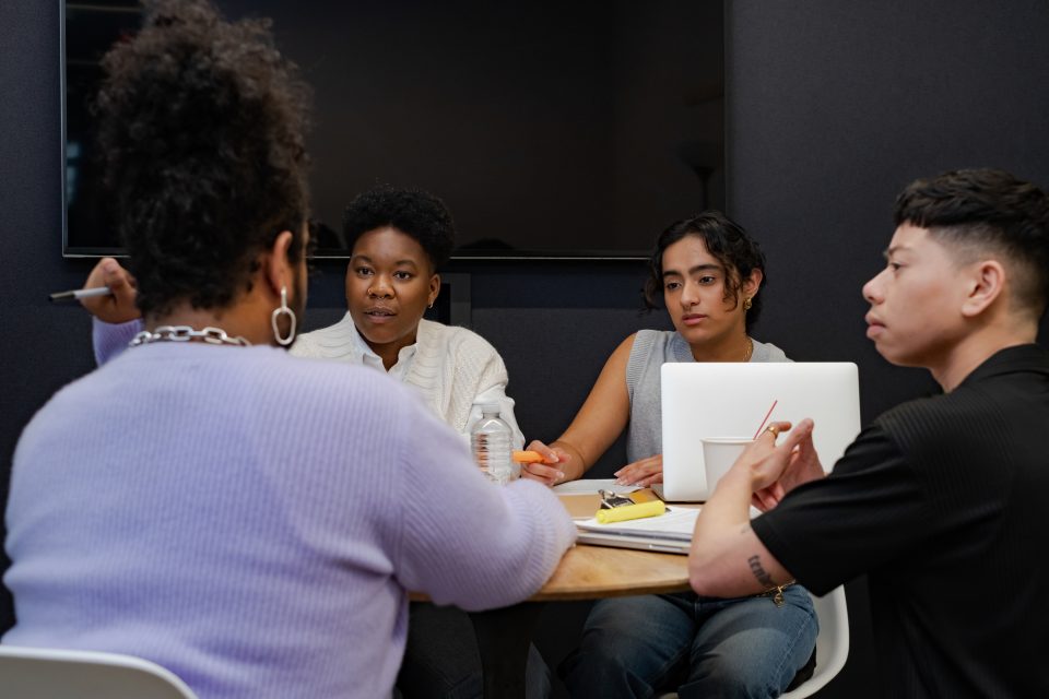Gender inclusive research: A group of people of varying genders having a meeting