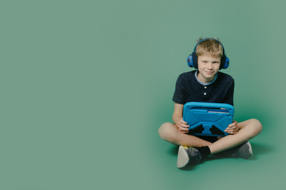 A young boy playing a game wearing ear defenders