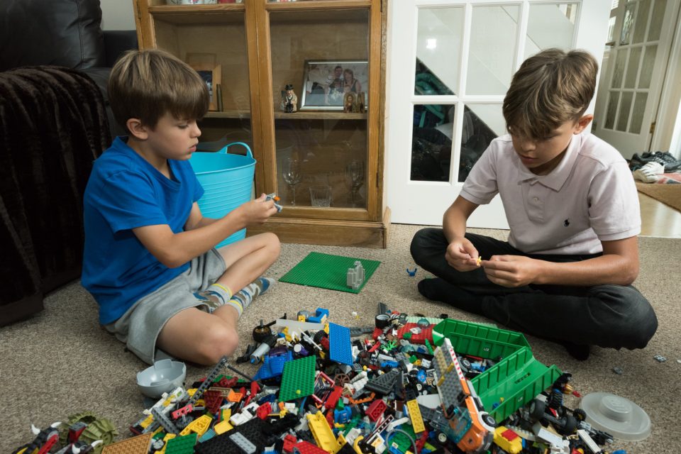 Autistic boy and brother playing with lego.