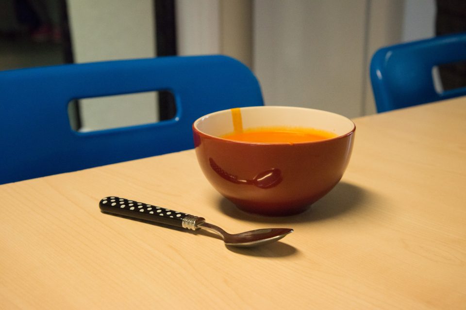 Bowl on untouched soup on a table.