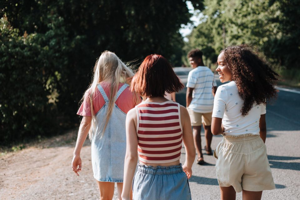 Group of young people outside walking away