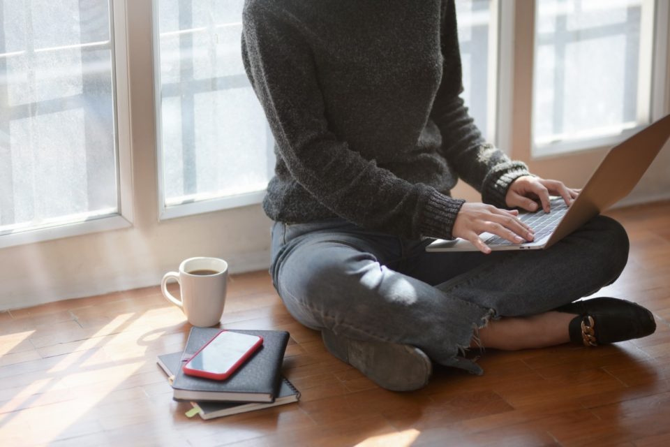 Woman on laptop with coffee