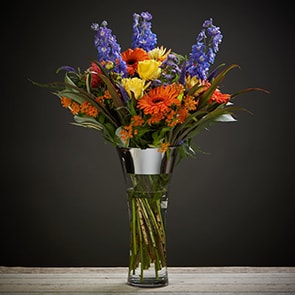 Bloom Magic - Flower Delivery Ireland - A striking mix of bright yellow, burned orange and deep blue shades make this our most vibrant bouquet. Perfect for that happy occasion or to put a big smile back on someone's face. A perfect gift for an engagement, birthday flowers or a thank-you gift. This boquet is available for next-day delivery all across Ireland and same day flower delivery in Dublin.