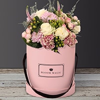 Jardins du Luxembourg is a beautiful arrangement of hatbox flowers featuring spray roses and vintage carnations. 