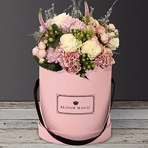 Jardins du Luxembourg is a beautiful arrangement of hatbox flowers featuring spray roses and vintage carnations. 