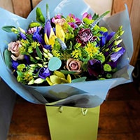 Bloom Magic - Flower Delivery Ireland - This is a stunning combination of flowers in the shades of the Seven Seas: bright blues, muted lilacs, and deep purple are set off by vivid lime green. Getting these flowers delivered along with candles or chocolates would be a brilliant gift for any occasion, especially Mother's Day.