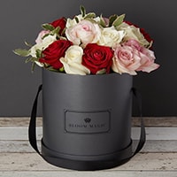 Bloom Magic - Flower Delivery Ireland - A vibrant bouquet containing a mixture of red and white roses. This flower arrangment comes in either a charcoal grey, or powder blue hatbox, and is perfect for any occasion. Same day flower delivery is available to Dublin and next day delivery is available to all of Ireland.