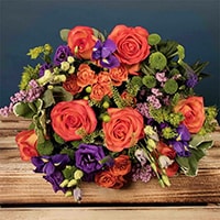 Bloom Magic - Flower Delivery Ireland - A lovely orange and purple bouquet featuring mango cala and mini gerbera. These flowers are classic and timeless and can be sent for any occasion. This tasteful arrangement is available for same-day delivery in Dublin and next-day flower delivery to all of Ireland.
