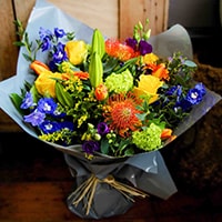 Bloom Magic - Flower Delivery Ireland - This flower bouquet is one of the most vibrant arrangements on the Bloom Magic platform. Burned orange, and deep blue flowers make it extremely suitable for any happy occasion. Getting these flowers delivered as Birthday flowers or to celebrate in any way, would put a smile on anyones face. Available for same dasy delivery in Dublin, and next day delivery nationwide.