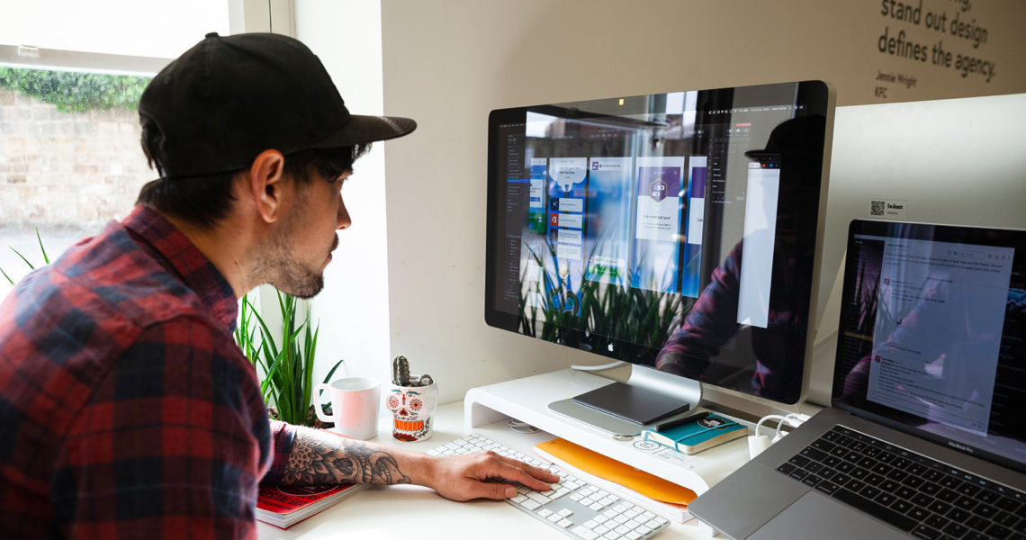 Jason the designer working on designs on his Mac