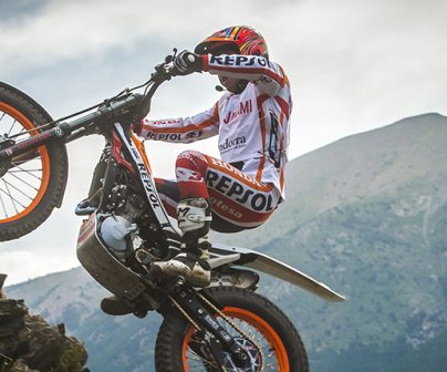 Takahisa Fujinami subiendo unas rocas con su moto