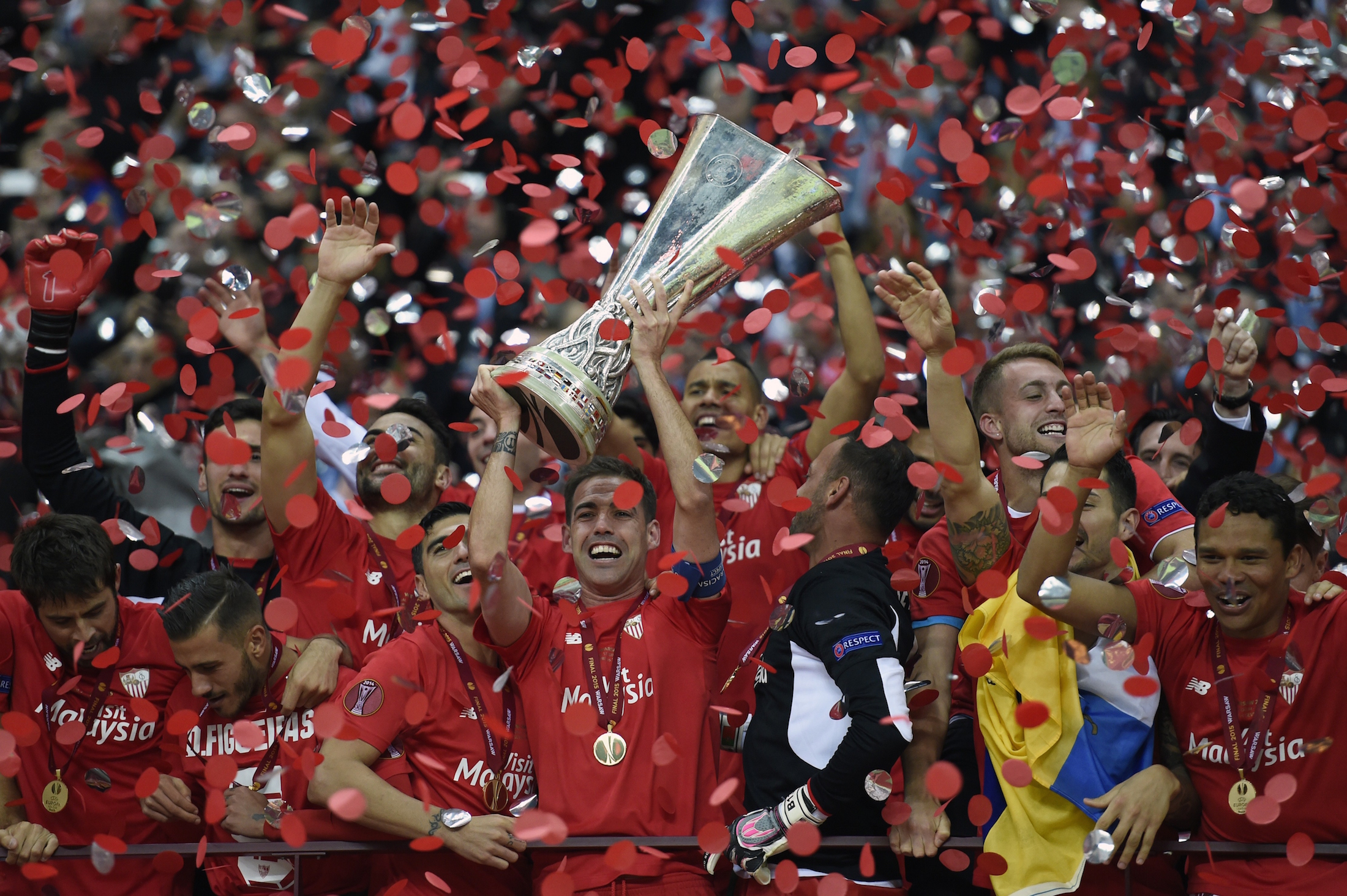 Sevilla players celebrate with trophy after the UEFA Europa League final football match between FC Dnipro Dnipropetrovsk and Sevilla FC at the Narodowy stadium in Warsaw, Poland on May 27, 2015. Sevilla FC won 2-3. AFP PHOTO / ODD ANDERSEN (Photo credit should read ODD ANDERSEN/AFP/Getty Images)