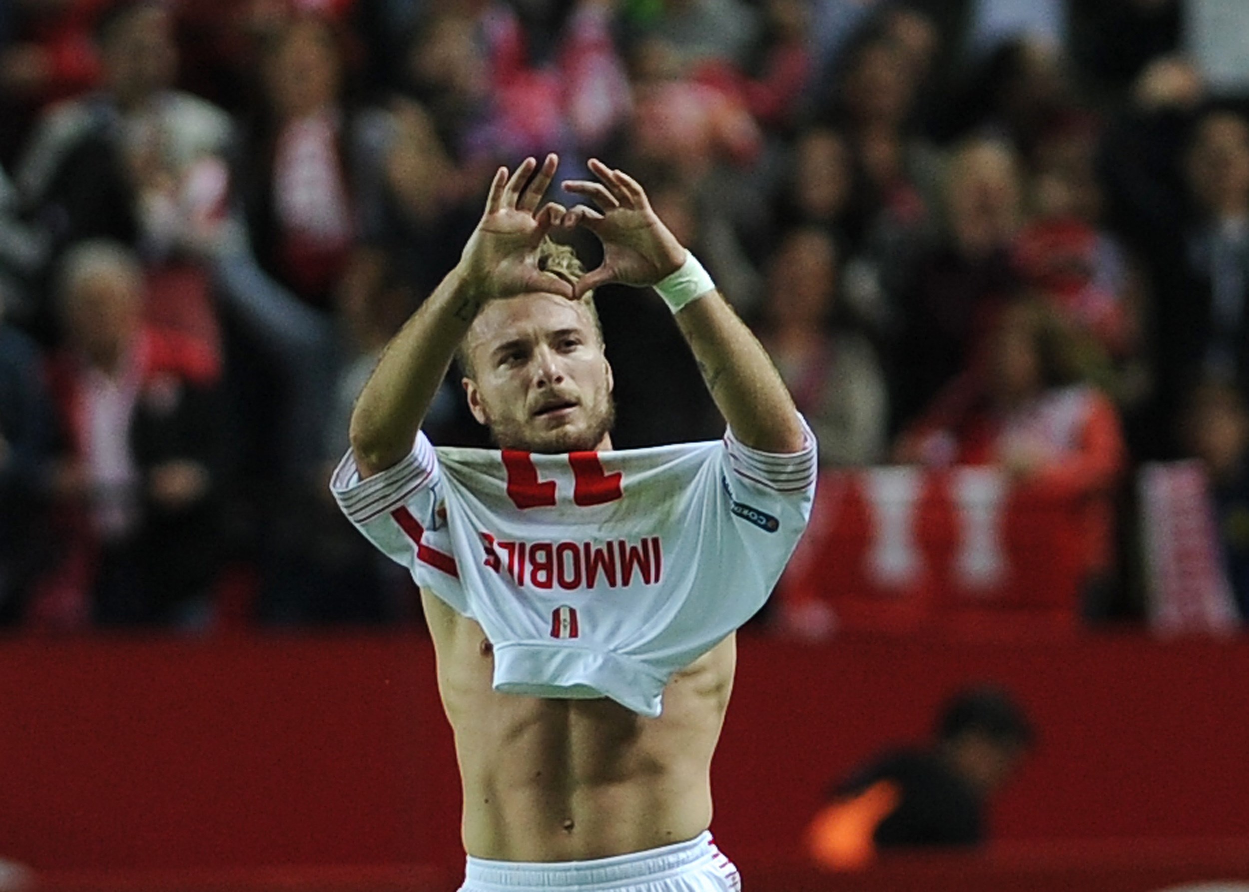 Sevilla's Italian forward Ciro Immobile celebrates after scoring during the Spanish league football match Sevilla FC vs Real Madrid CF at the Ramon Sanchez Pizjuan stadium in Sevilla on November 8, 2015. AFP PHOTO/ CRISTINA QUICLER (Photo credit should read CRISTINA QUICLER/AFP/Getty Images)