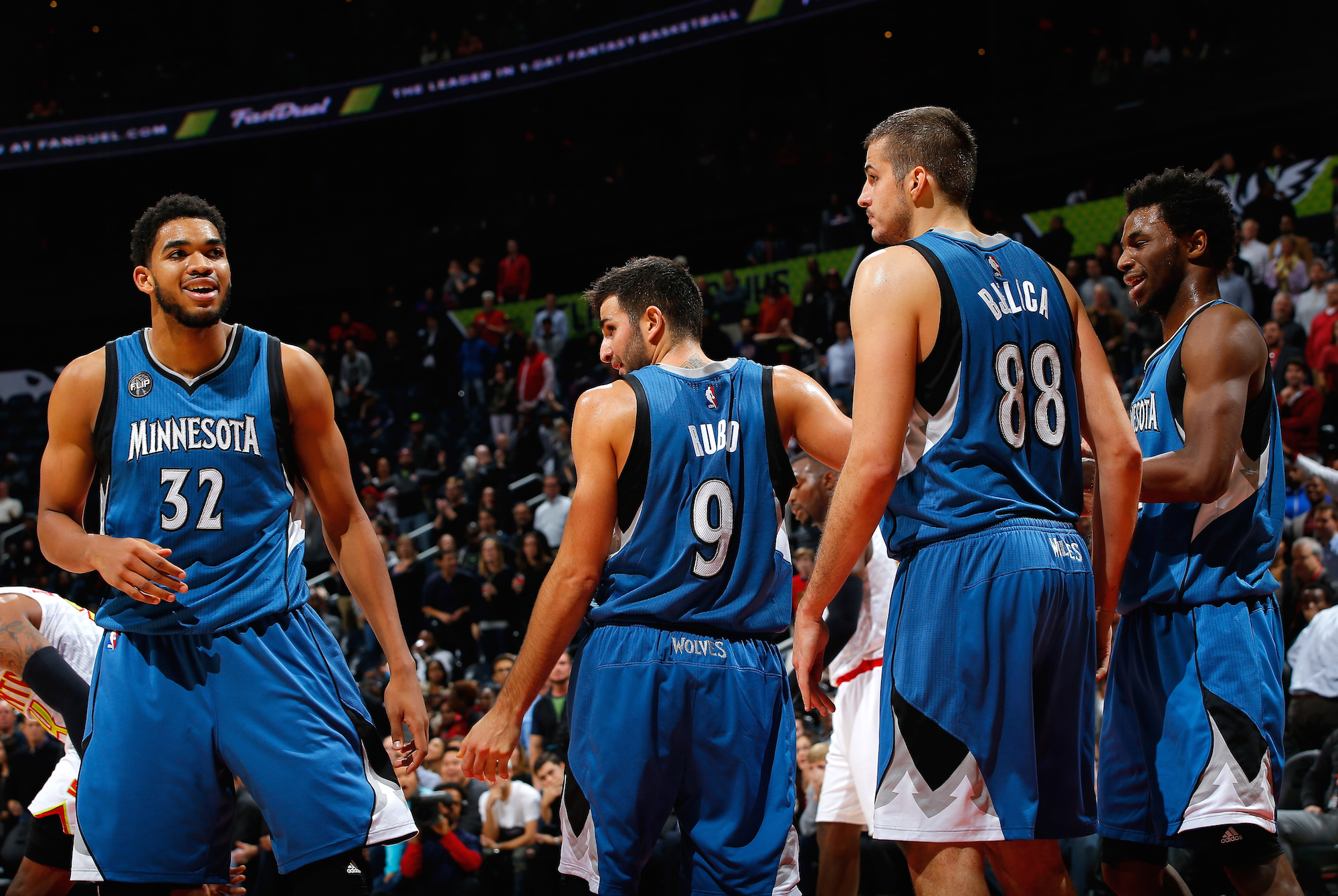 ATLANTA, GA - NOVEMBER 09: Karl-Anthony Towns #32 and Andrew Wiggins #22 of the Minnesota Timberwolves react after Ricky Rubio #9 draws a charge from Kent Bazemore #24 of the Atlanta Hawks at Philips Arena on November 9, 2015 in Atlanta, Georgia. NOTE TO USER User expressly acknowledges and agrees that, by downloading and or using this photograph, user is consenting to the terms and conditions of the Getty Images License Agreement. (Photo by Kevin C. Cox/Getty Images)